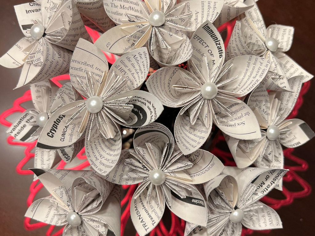 A bouquet of paper flowers with white pearl centers.