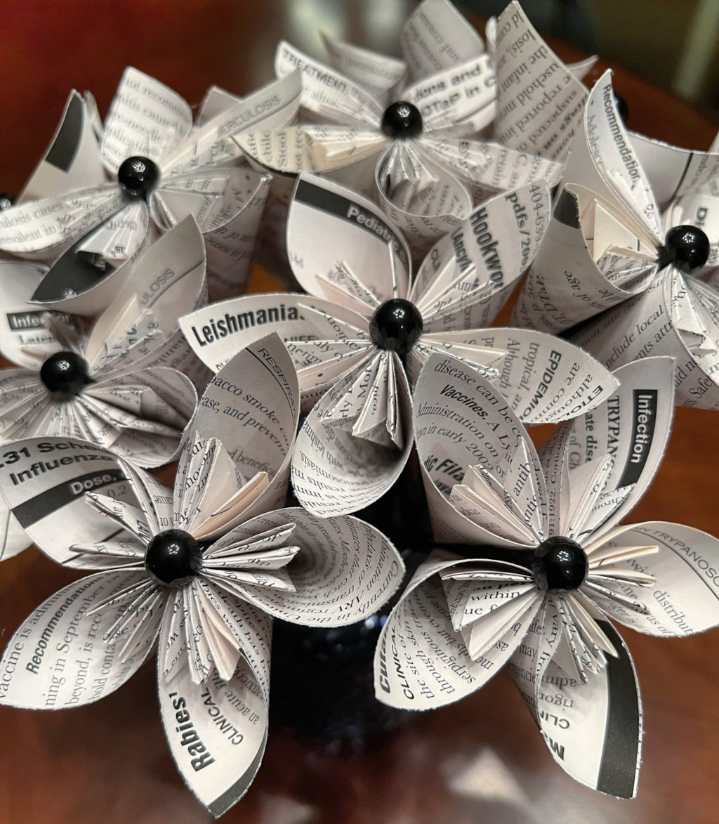 A small bouquet of paper flowers with black pearl centers.